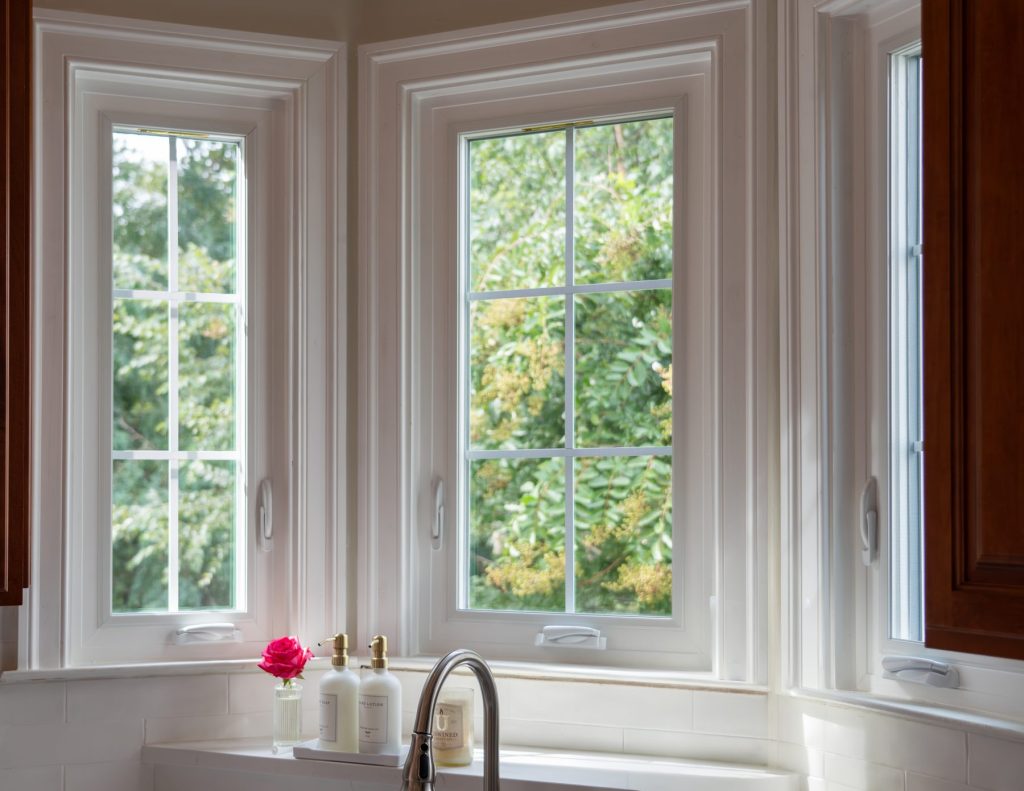 Vytex white corner casement windows above a bathtub