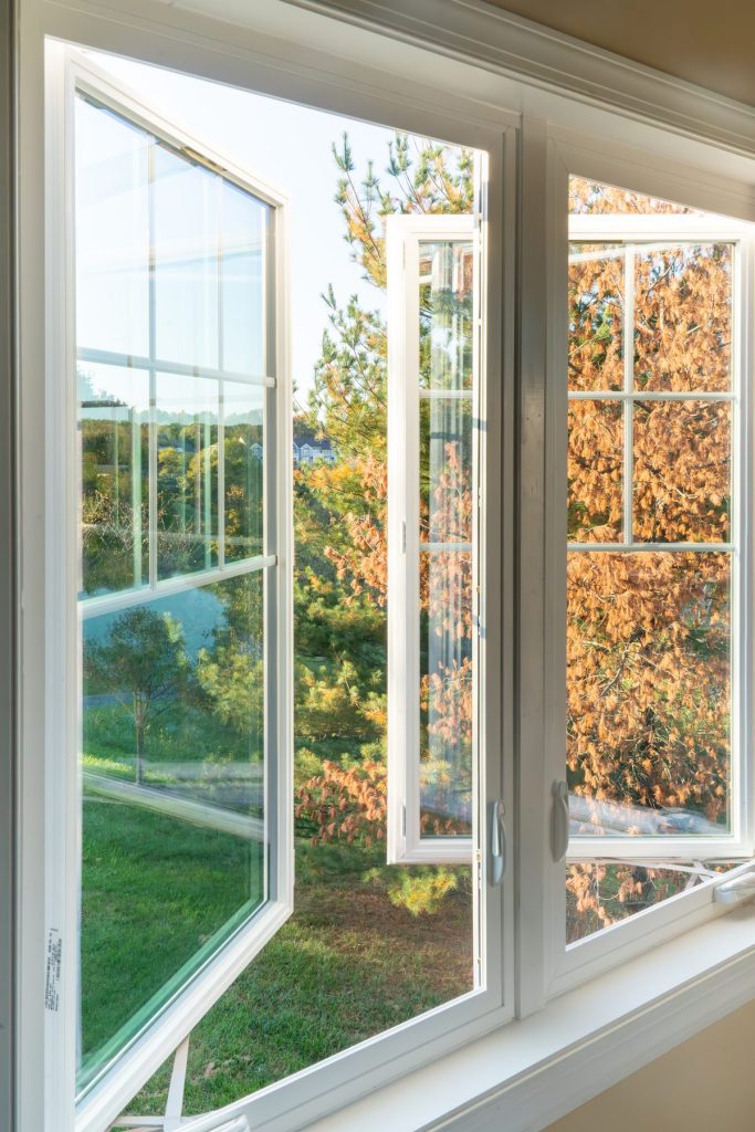 Vytex casement window cranked fully open to a garden