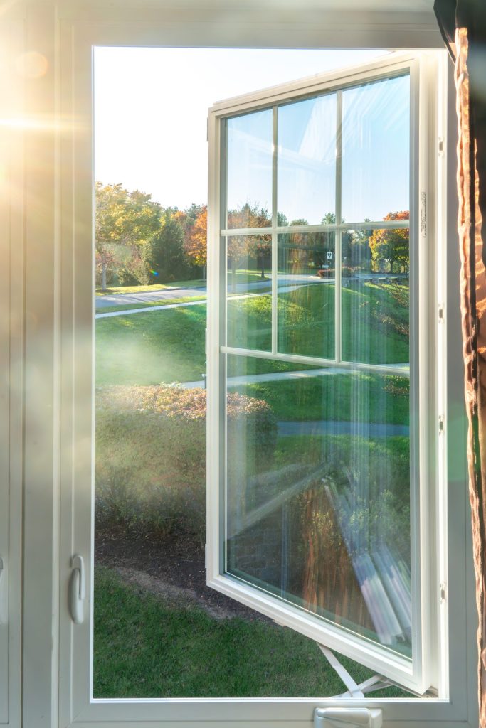 Vytex white casement window open at sunset