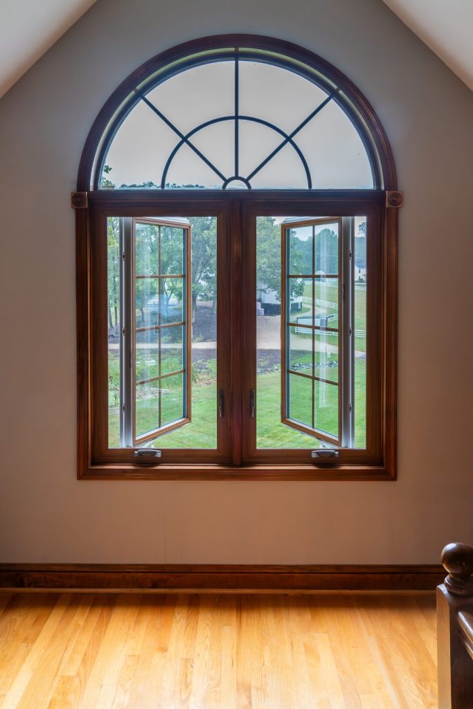 Vytex woodgrain casement bay with an arched transom