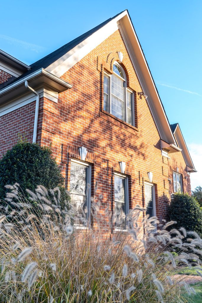 Vytex Fortis beige double-hung windows on a brick exterior