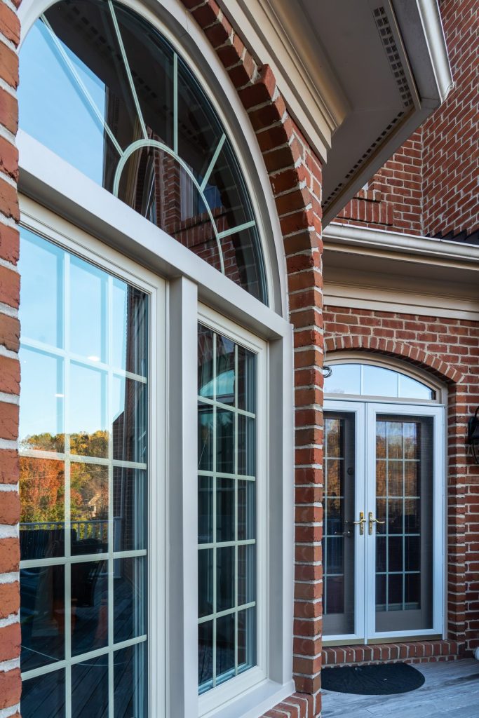Vytex Fortis windows with colonial grids on a brick home