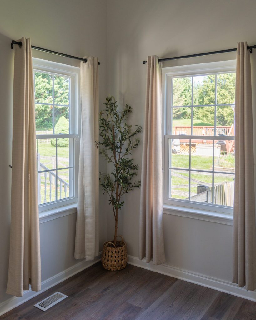 Two Vytex Fortis white windows in a corner room