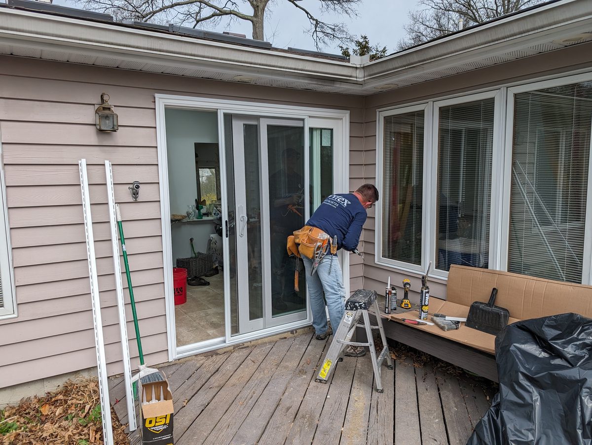 Vytex factory-certified installer fitting a sliding glass patio door