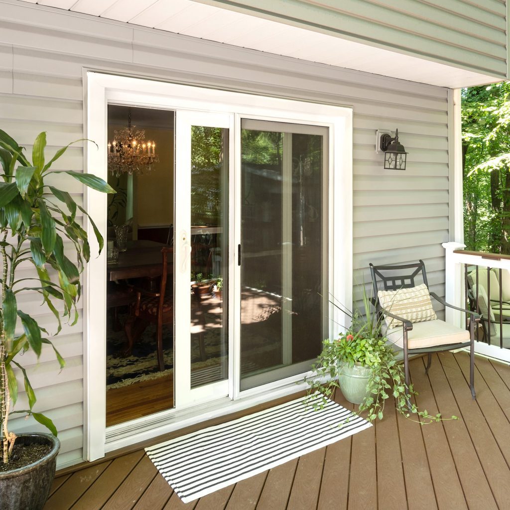 Vytex Signature Series white sliding patio door viewed from a deck