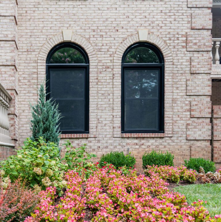 True Black exterior Vytex windows with an arched top