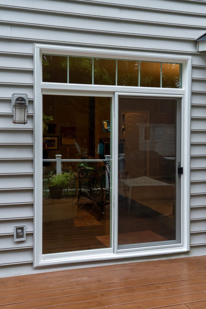 Vytex 7000 Series white sliding patio door on gray siding
