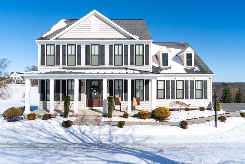 Vytex Potomac-HP windows with True Black exterior and colonial grids on a white colonial home